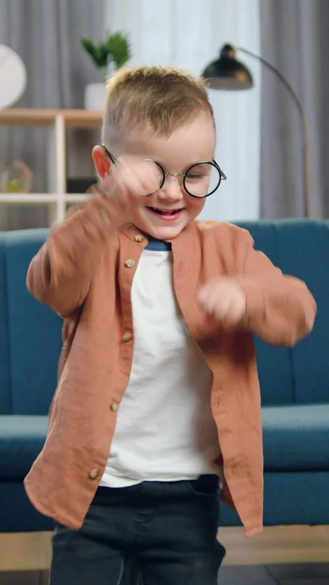 Portrait of nice funny light-haired 2-aged boy in stylish clothes which doing da Stock Footage 328706292