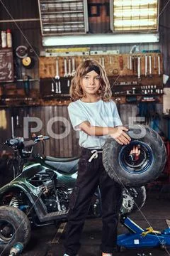 Portrait of nice little girl at auto service workshop Stock Photos