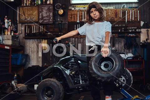 Portrait of nice little girl at auto service workshop Stock Photos