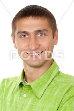 Portrait of a nice young guy in a green dress in studio on white Stock Photos