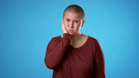 Portrait of non binary gender fluid woman 20s with tooth dental ache pain Stock Footage 223579721