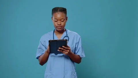 Portrait of nurse working on digital tablet with touch screen Stock Footage 164399801