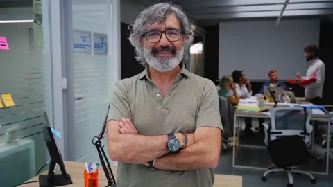 Portrait of office man smiling and looking at camera. In the background there is Stock Footage 245666264