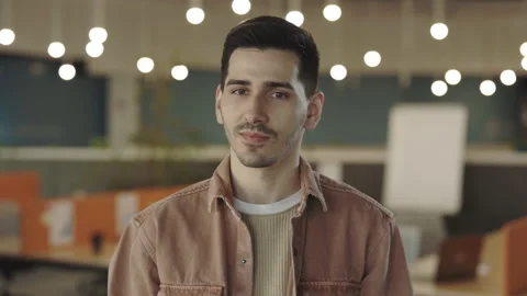 Portrait of office manager looking to camera at coworking zone. Young caucasian Stock Footage 197507902