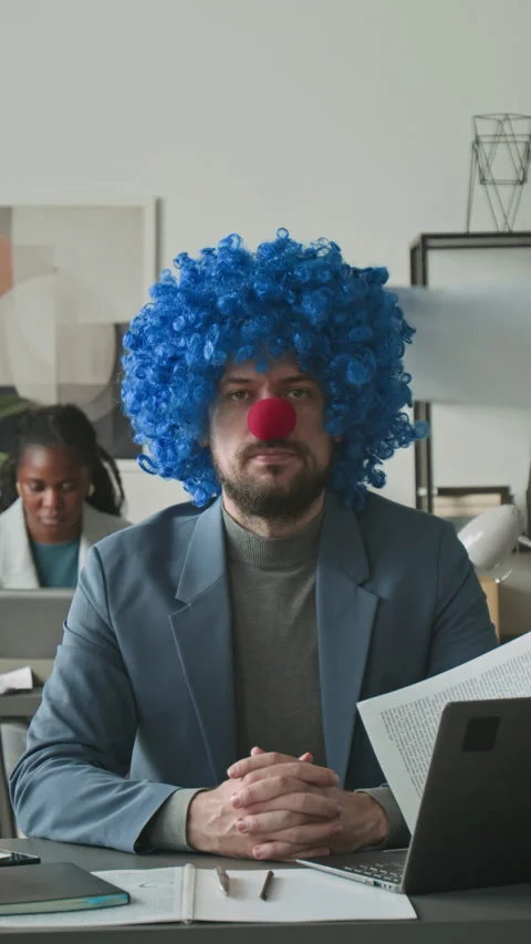 Portrait of Office Worker with Clown Wig and Nose as Papers Flying Around Him Stock Footage 295345216