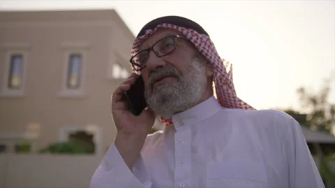Portrait of an old arab man talking on the mobile Stock Footage 135719187
