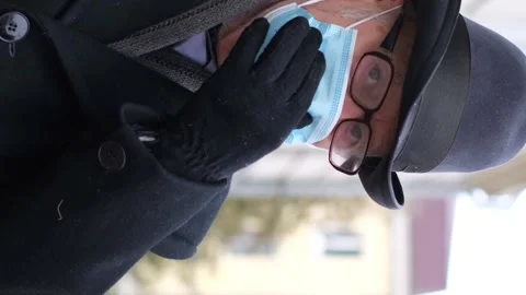 Portrait of an old elderly man with a blue mask on his face, he looks at the Stock-Footage 252418289