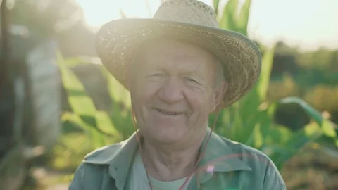 Portrait of the old farmer in a field smiling and speaking at camera 4K Video stock 80968478