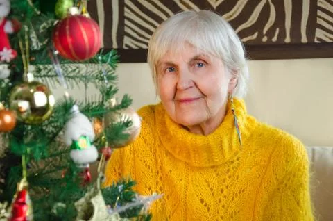 Portrait of old grandmother at home in new year. caucasian positive, friendly Stock Photos