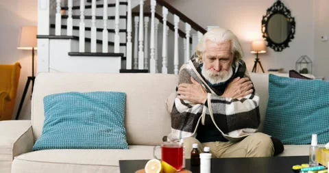 Portrait of old grey-haired sick man in warm plaid sitting on sofa indoor and Stock Footage 141322078