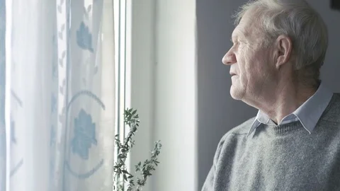 Portrait of old handsome man looking at windows and smiling to camera 4K Video stock 69756692