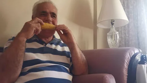 Portrait Of Old Man Eating Corn 3 Stock Footage 142631252