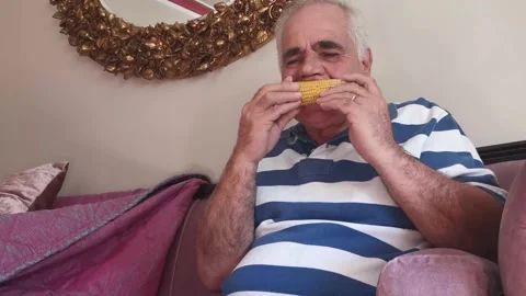 Portrait Of Old Man Eating Corn 5 Stock Footage 142631271