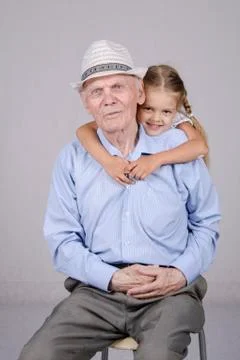 Portrait of an old man eighty years with granddaughter Stock Photos