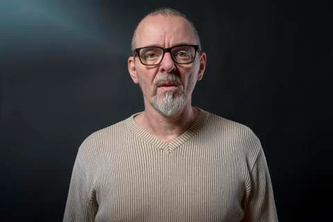 Portrait of an old man with gray beard and glasses Stock Photos