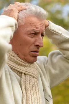 Portrait of an old man having a headache Stock Photos