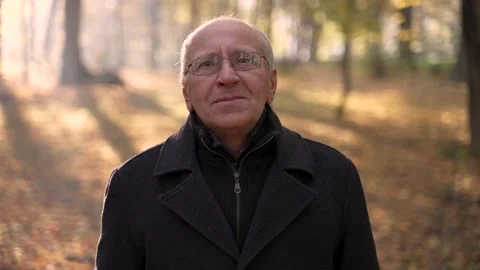 Portrait of old man posing on camera in park Stock Footage 168186359