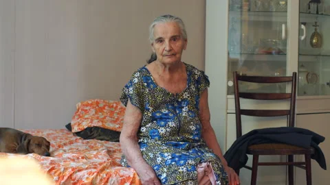 Portrait of an old sick eighty-year-old woman at home on the couch. Stock Footage 112636754
