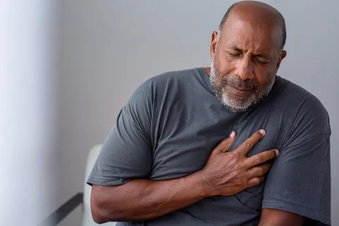Portrait of an older senior man having chest pain. Stock Photos