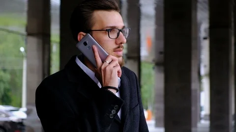 Portrait one serious manager in classic costume and in glasses stands on the Stock Footage 86079325