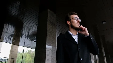 Portrait one serious manager in classic costume and in glasses stands on the Stock Footage 86084252