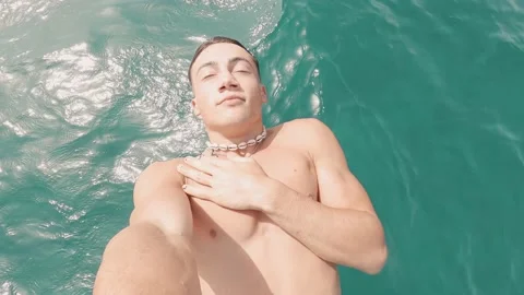 Portrait of one young man falling and sliding to the water with eyes closed enjo Stock Footage 171894492