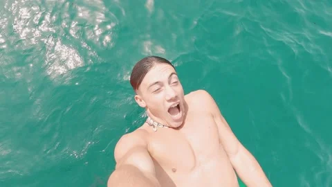 Portrait of one young man falling and sliding to the water with eyes closed enjo Stock Footage 171895628