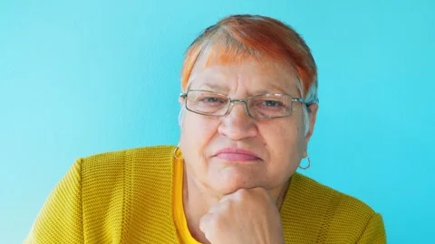 Portrait of an optimistic 70-year-old grandmother looking at the camera. Video stock 252348437