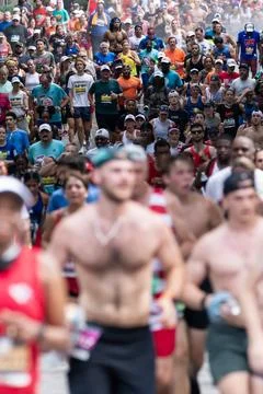 Portrait orientation shows thousands running in Atlanta Peachtree Road Race Stock Photos