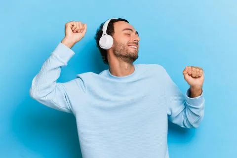 Portrait of overjoyed positive handsome man in casual jumper and white Stock-Fotos