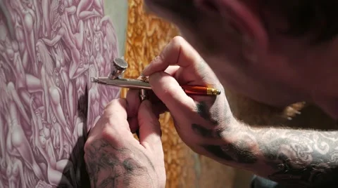 Portrait of painter airbrusher in art studio. Man with tattooed hands. Stock Footage 59779194