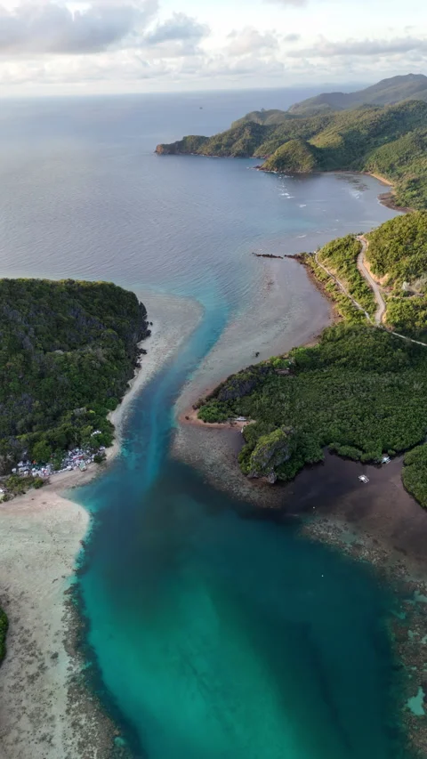Portrait panning drone shot over Linapacan coastal channel highlighting the Stock Footage 332386865