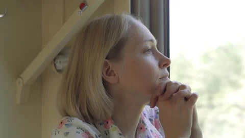 Portrait of a passenger looking out of the window during a train ride Stock Footage 161074598