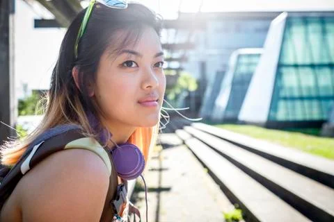 Portrait of pensive Chinese woman with headphones Stock Photos