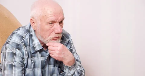 Portrait of a pensive elderly man with gray hair touching his beard and looking Stock Footage 151022110