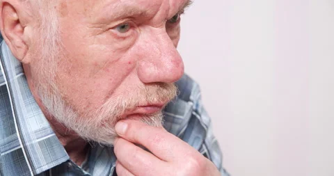 Portrait of a pensive elderly man touching his beard and looking to the side Stock Footage 147051235