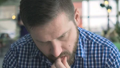 Portrait of pensive man, browsing smartphone, in cafe, very close steadycam shot 库存影片 72952358