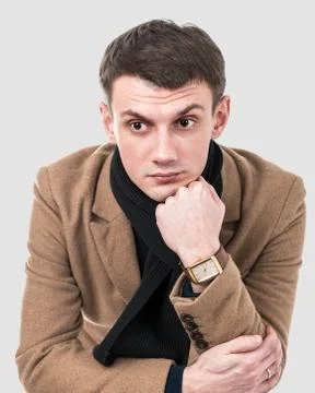 Portrait of a pensive man on a gray background Stock Photos