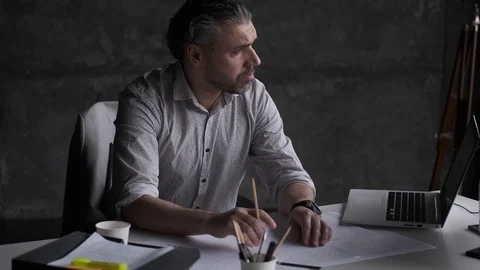 Portrait of a pensive middle-aged man in the office. Stock Footage 107329247