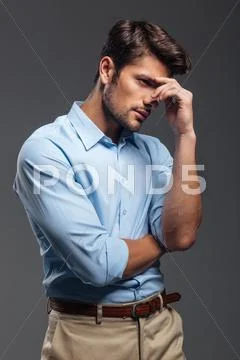 Portrait of a pensive young man looking away Stock Photos
