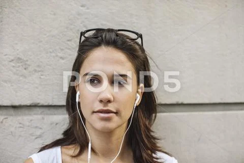 Portrait Of Pensive Young Woman With Ear Phones