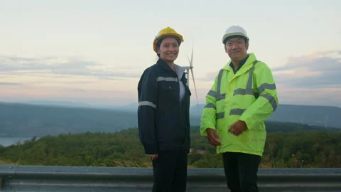 Portrait of people engineer are standing in a field wearing a protective helm Stock Footage 169241279