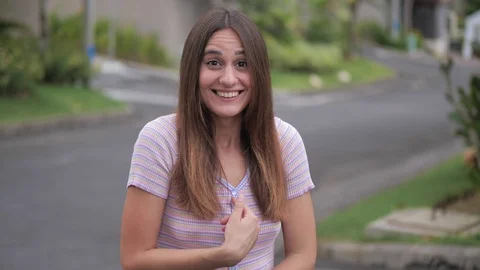 Portrait of perplexed girl in looking camera, pointing herself, say who me no Stock Footage 124895926