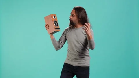 Portrait of person having fun holding speakers, listening music Stock Footage 319467337