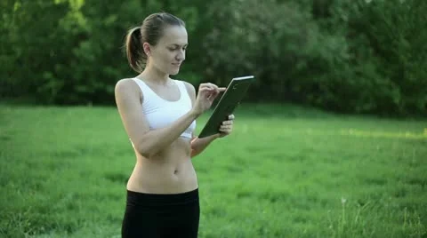 Portrait of personal trainer with tablet computer outdoors  HD Stock Footage 10962160