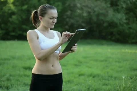 Portrait of personal trainer with tablet computer outdoors NTSC Stock Footage 10962164