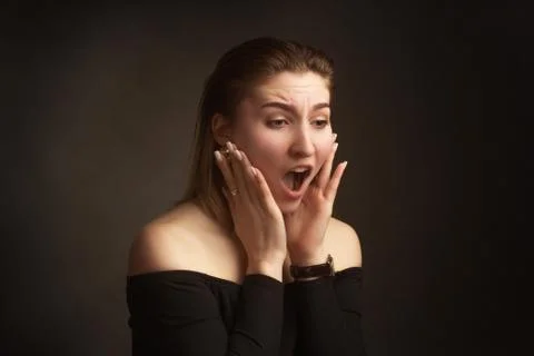 Portrait in the photo Studio of a brown-haired girl, on a black background in Stock Photos