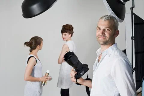 Portrait of a photographer on a fashion shoot Stock Photos