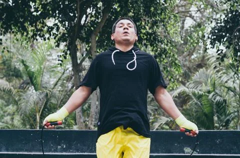 Portrait of a physically fit man posing with skipping rope. Stock Photos