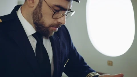 Portrait of pilot using the tablet, while waiting the flight inside the private Stock Footage 111066267